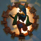 Round Metal Frame Ganesha playing the flute